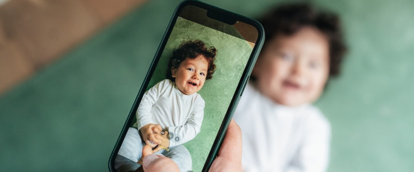 Mother taking photo of her baby