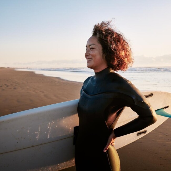Woman with a surfboard on a beach
